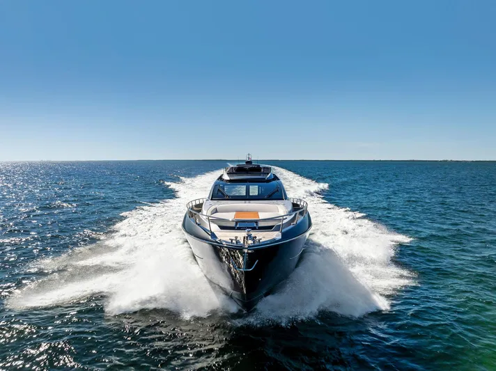 Arcadia Yacht Photos Pics 2020 Riva 66' Ribelle yacht cruising on open sea under clear blue sky.