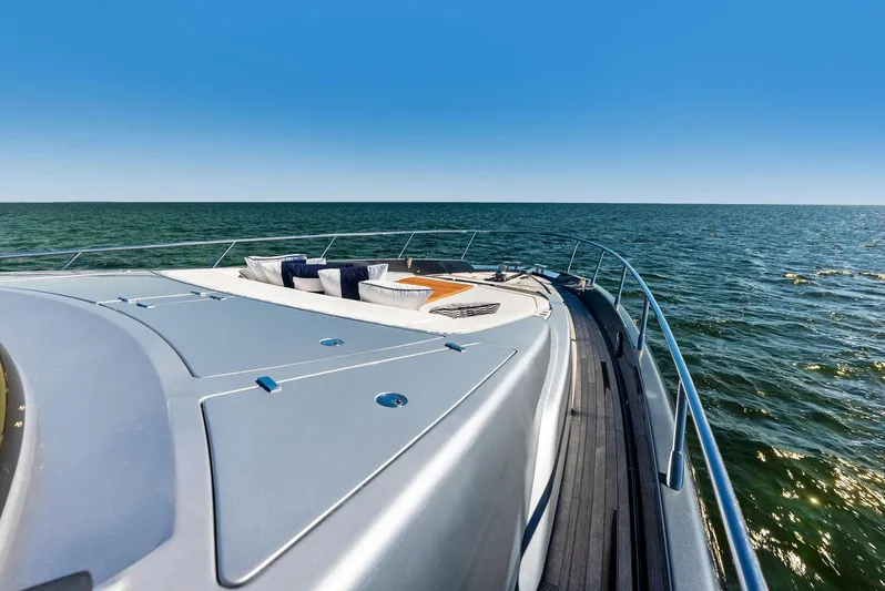 Arcadia Yacht Photos Pics Riva 66' Ribelle 2020 yacht cruising on open sea under clear blue sky.