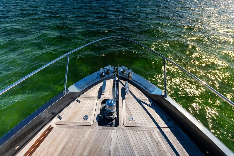 Arcadia Yacht Photos Pics Bow of 2020 Riva 66' Ribelle yacht on shimmering green water.