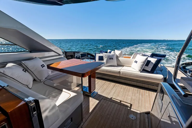 Arcadia Yacht Photos Pics Luxurious 2020 Riva 66' Ribelle yacht interior with elegant seating and ocean view.
