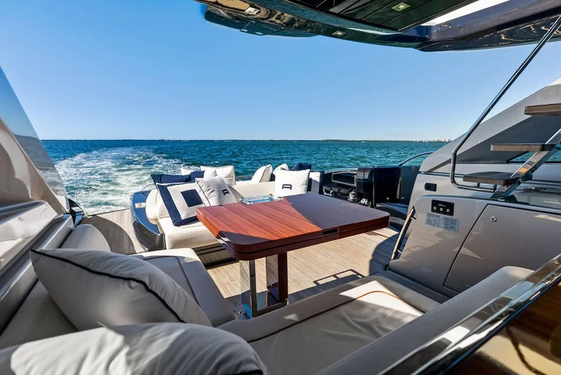 Arcadia Yacht Photos Pics Luxurious 2020 Riva 66' Ribelle yacht with elegant deck seating and ocean view.