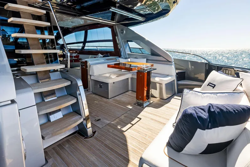 Arcadia Yacht Photos Pics Luxurious 2020 Riva 66' Ribelle yacht interior with elegant seating and wooden accents.