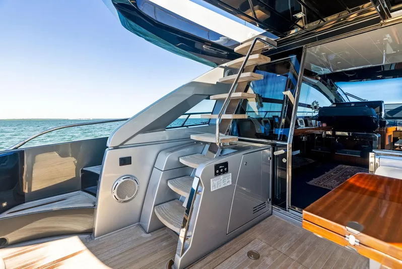 Arcadia Yacht Photos Pics Luxurious 2020 Riva 66' Ribelle yacht interior with sleek staircase and modern design.