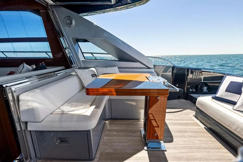 Arcadia Yacht Photos Pics Luxurious 2020 Riva 66' Ribelle yacht interior with elegant seating and wooden table.