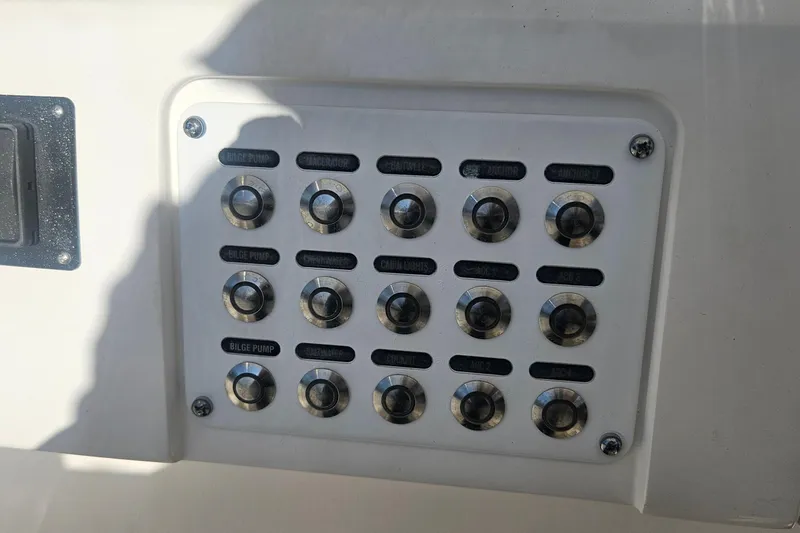  Yacht Photos Pics Control panel on a 2015 Intrepid 327 Center Console boat with labeled switches.