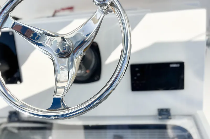  Yacht Photos Pics Chrome steering wheel on a 2016 Whitewater boat dashboard.