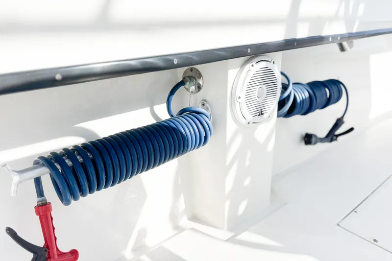  Yacht Photos Pics 2016 Whitewater boat deck with coiled blue hose and speaker.