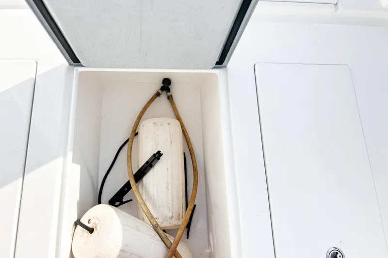  Yacht Photos Pics Storage compartment on a 2016 Whitewater boat with hoses and fenders.