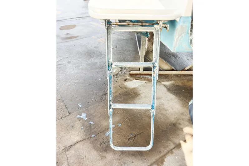  Yacht Photos Pics Metal boat ladder attached to a Whitewater vessel, 2016 model, on a wet concrete surface.