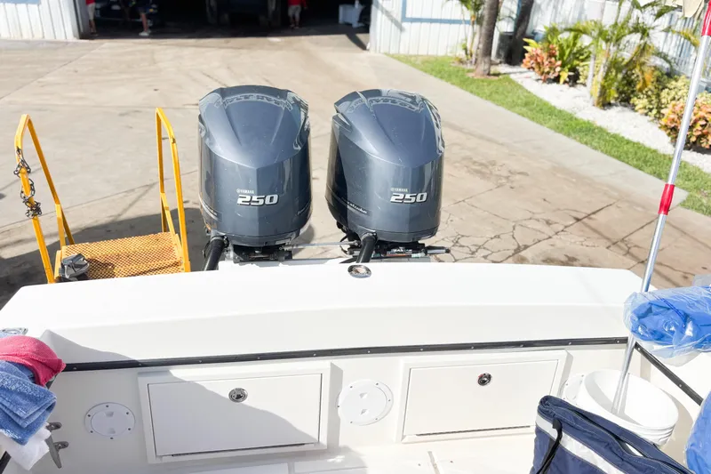  Yacht Photos Pics Twin Yamaha 250 outboard engines on a 2016 Whitewater boat, docked with equipment.