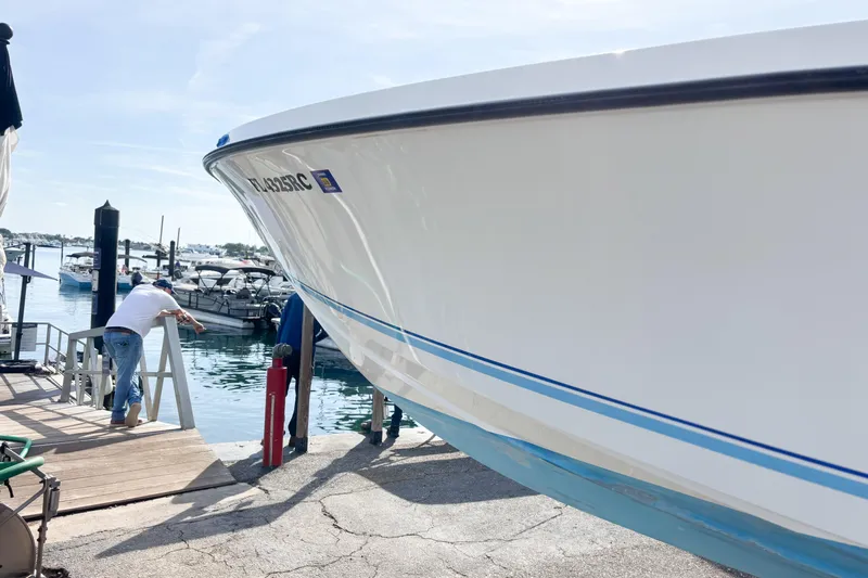  Yacht Photos Pics Whitewater boat docked at marina, 2016 model, with person adjusting ropes.