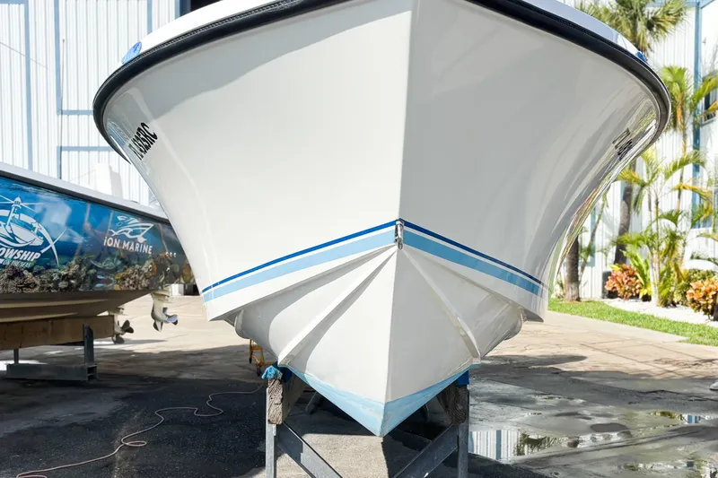  Yacht Photos Pics Front view of a 2016 Whitewater boat on a stand, with blue stripes.