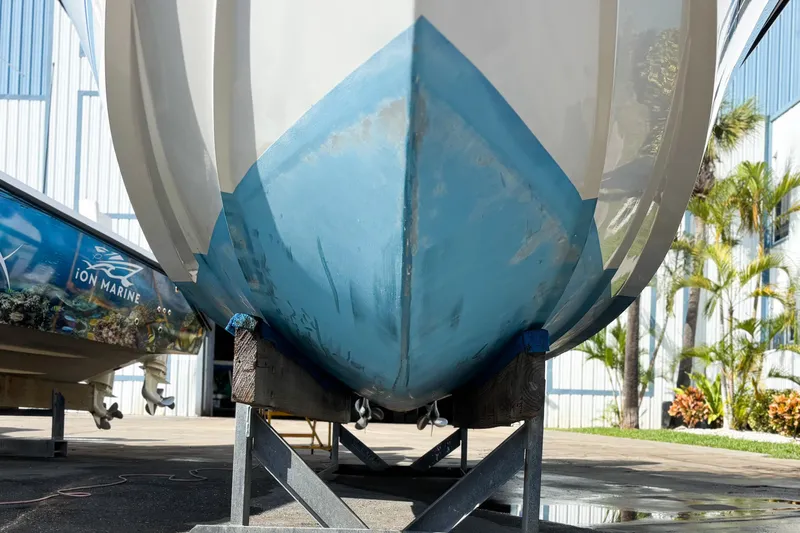  Yacht Photos Pics 2016 Whitewater boat hull on trailer, outdoor setting with palm trees.