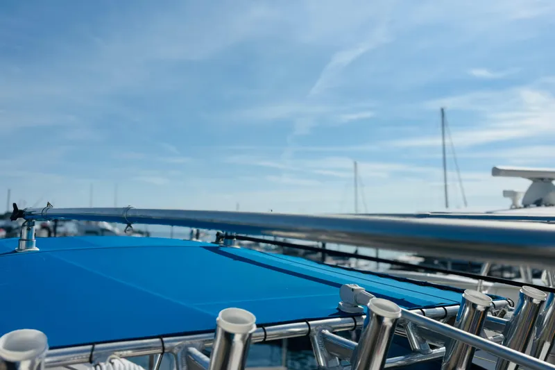  Yacht Photos Pics Blue canopy on a 2016 Whitewater boat under a clear sky.