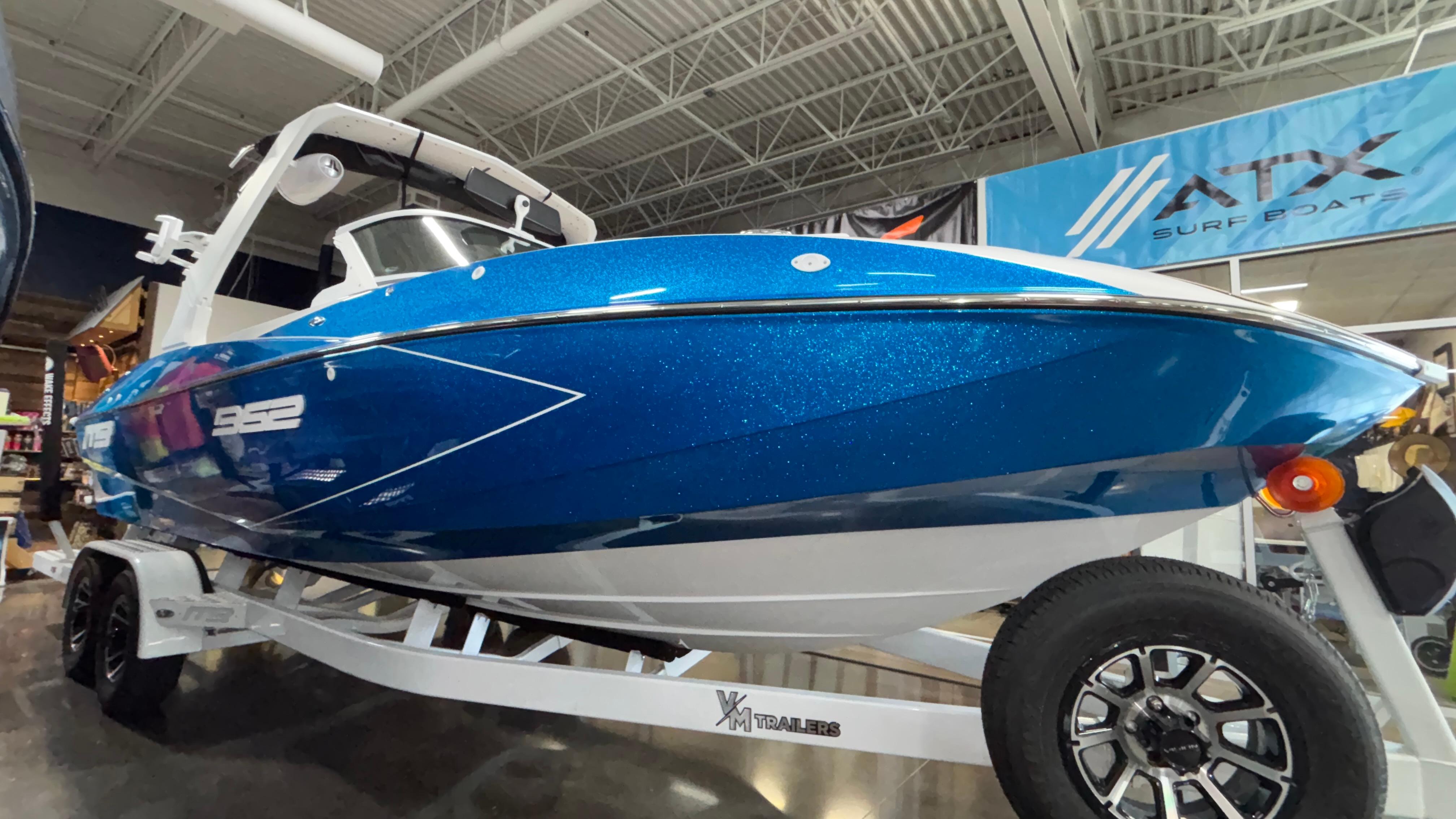 2025 MB B52 23 Classic boat in showroom, blue exterior, on trailer.
