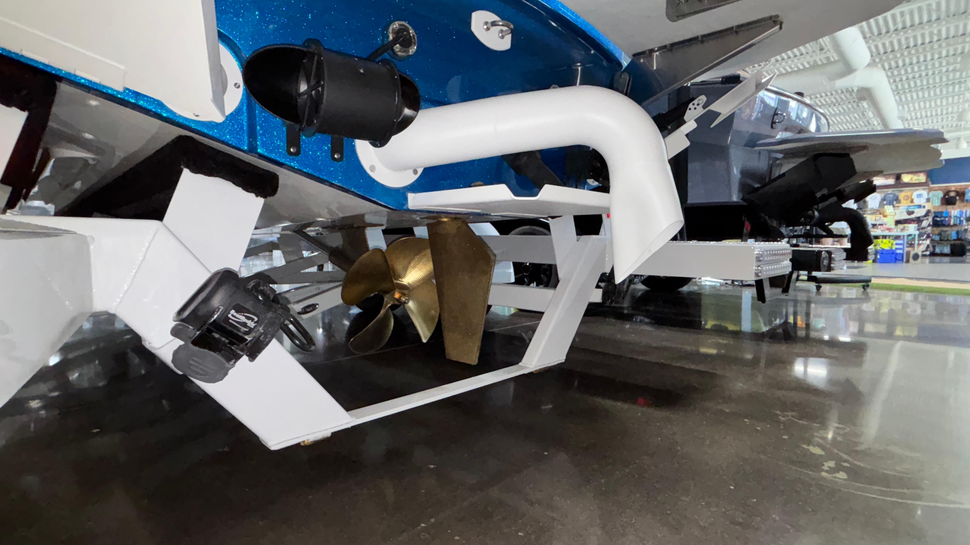 2025 MB B52 23 Classic boat propeller and exhaust system in showroom.