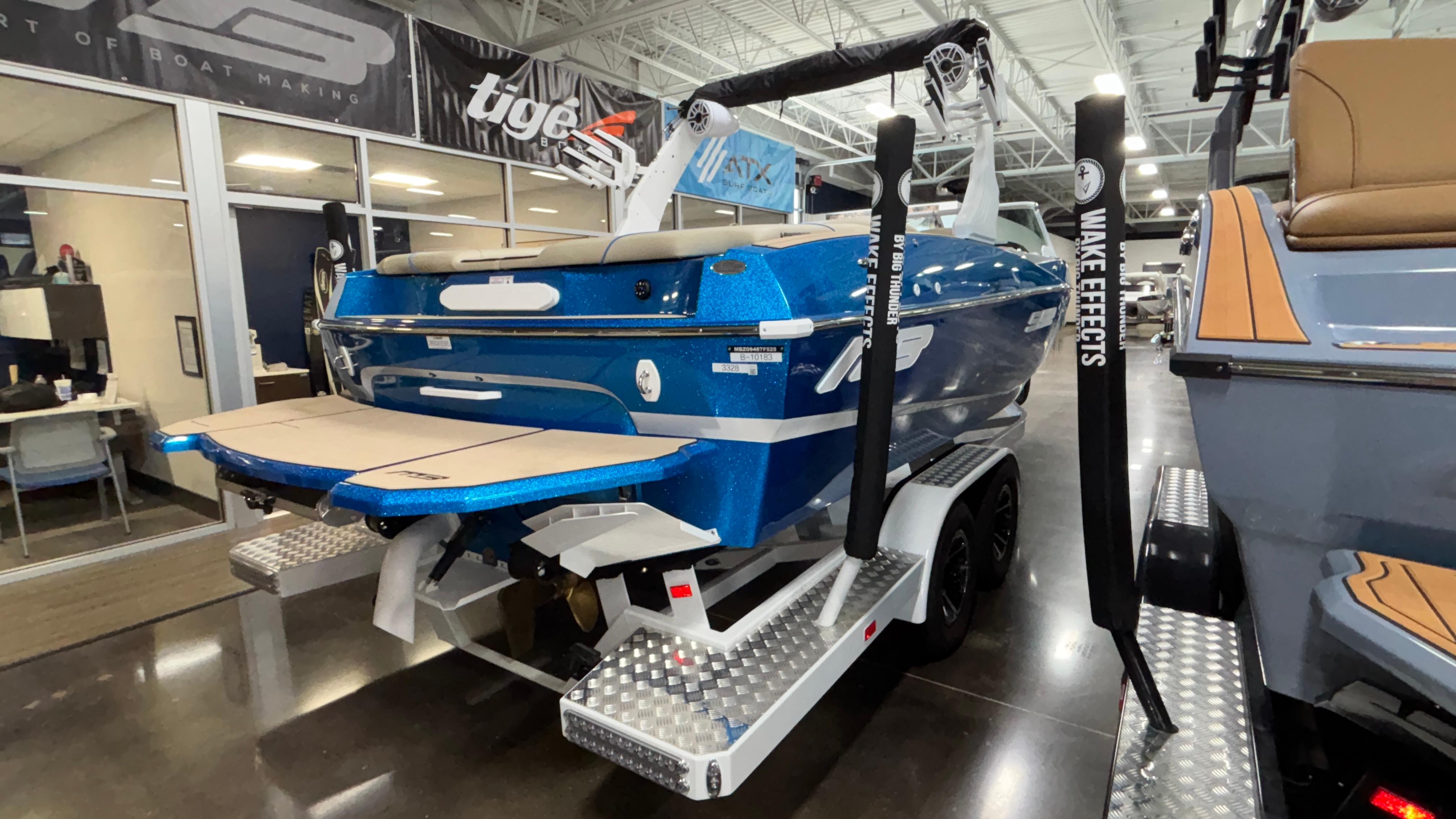 2025 MB B52 23 Classic boat in showroom, blue exterior, on trailer.