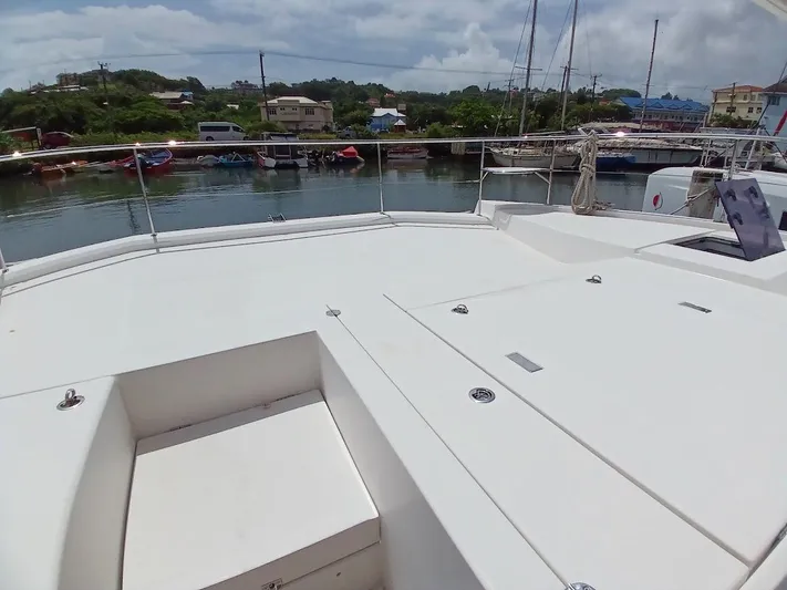High Life Yacht Photos Pics Leopard 43 Powercat 2020 on calm water, showcasing spacious deck and scenic marina backdrop.