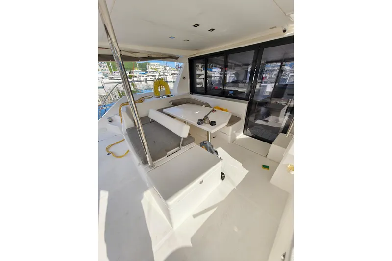 High Life Yacht Photos Pics 2020 Leopard 43 Powercat interior with seating and table, docked at marina.