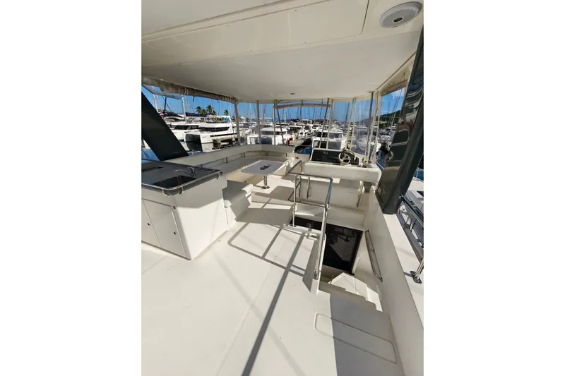 High Life Yacht Photos Pics 2020 Leopard 43 Powercat yacht interior with helm, seating, and marina view.