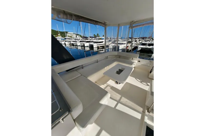 High Life Yacht Photos Pics 2020 Leopard 43 Powercat interior with white seating and table, docked at marina.