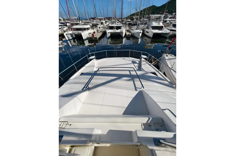 High Life Yacht Photos Pics 2020 Leopard 43 Powercat yacht docked in a marina, surrounded by other boats.