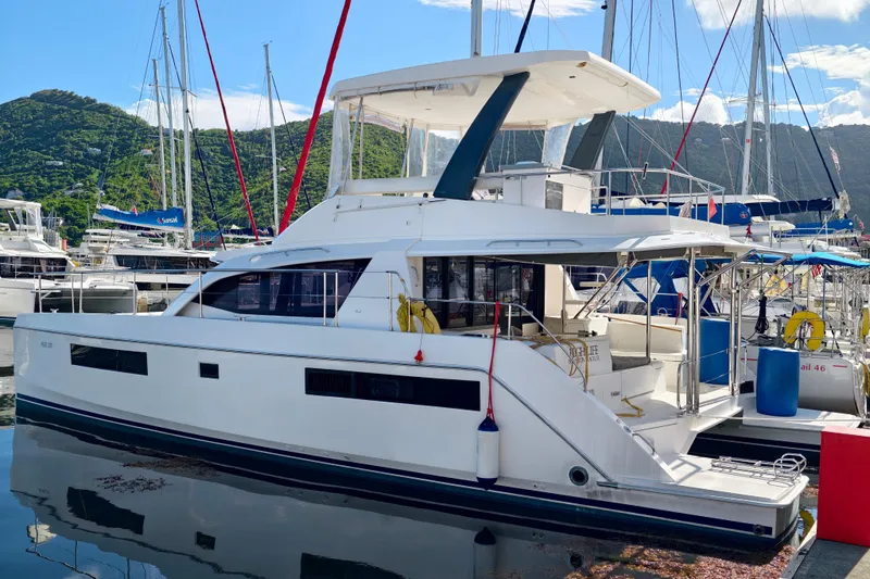 High Life Yacht Photos Pics 2020 Leopard 43 Powercat yacht docked in a marina with scenic mountain backdrop.