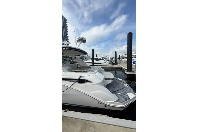 Mercy Yacht Photos Pics 2021 Sea Ray Sundancer 320 yacht docked at marina under blue sky.