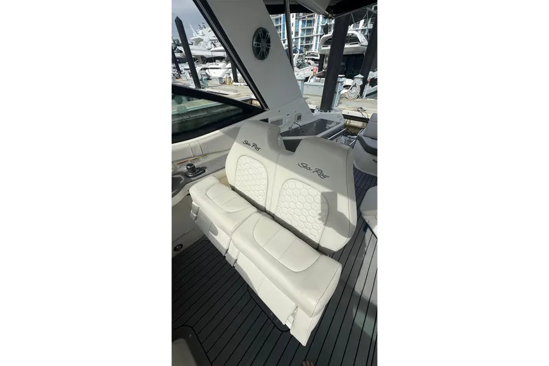 Mercy Yacht Photos Pics 2021 Sea Ray Sundancer 320 interior with white leather seating at marina.