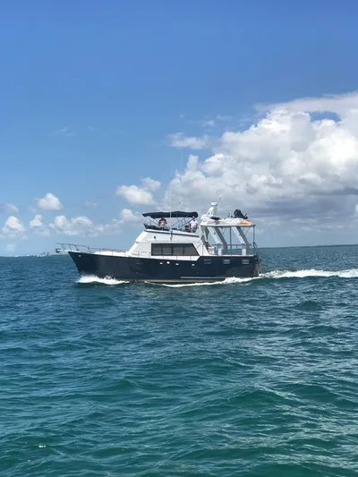  Yacht Photos Pics 1983 Sea Ranger 45 Sundeck cruising on open water under a clear blue sky.