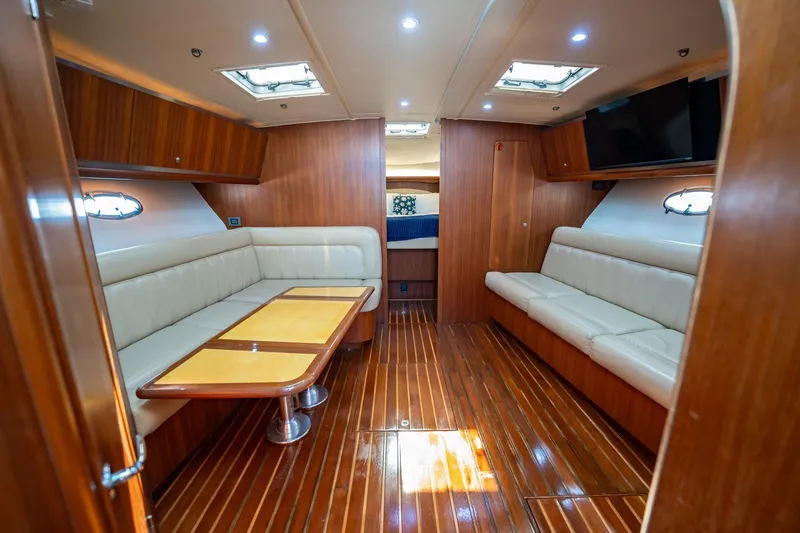Blue Pearl Yacht Photos Pics Luxurious interior of 2004 Tiara Yachts 4200 Open with wood finish and plush seating.