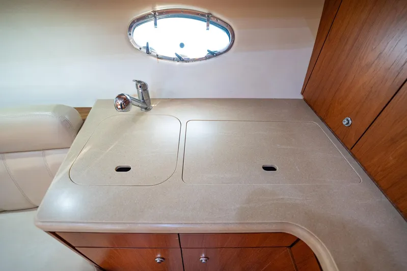 Blue Pearl Yacht Photos Pics 2004 Tiara Yachts 4200 Open galley with sink and wooden cabinetry.