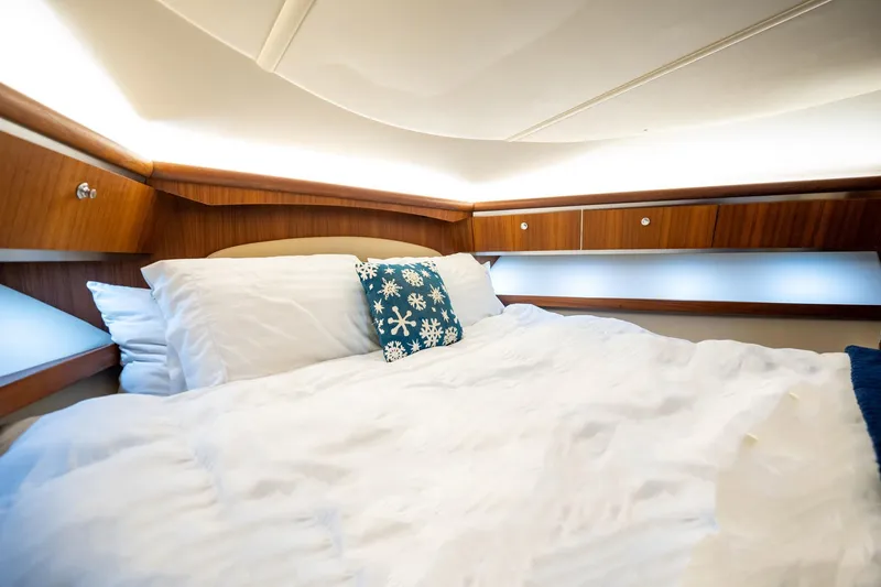 Blue Pearl Yacht Photos Pics Luxurious cabin interior of 2004 Tiara Yachts 4200 Open with cozy bedding.