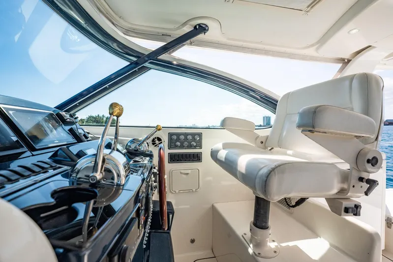 Blue Pearl Yacht Photos Pics 2004 Tiara Yachts 4200 Open helm with white captain's chair and control panel.