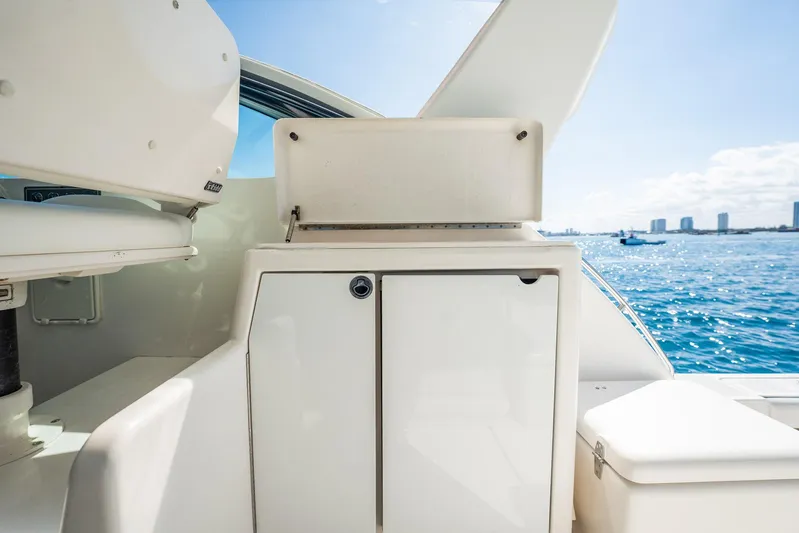 Blue Pearl Yacht Photos Pics 2004 Tiara Yachts 4200 Open, featuring sleek white cabinetry, with ocean and skyline backdrop.