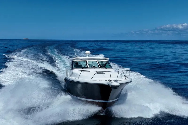 Blue Pearl Yacht Photos Pics 2004 Tiara Yachts 4200 Open cruising on open ocean under clear blue sky.