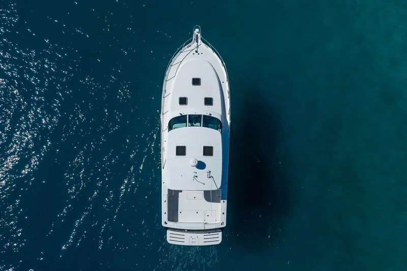 Blue Pearl Yacht Photos Pics Aerial view of 2004 Tiara Yachts 4200 Open on clear blue water.