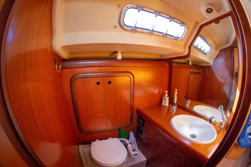  Yacht Photos Pics Luxurious 2005 Grand Soleil 43 yacht bathroom with wooden cabinetry and dual sinks.