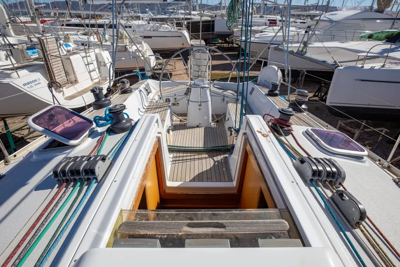  Yacht Photos Pics 2005 Grand Soleil 43 sailboat deck with winches and colorful ropes in a marina.