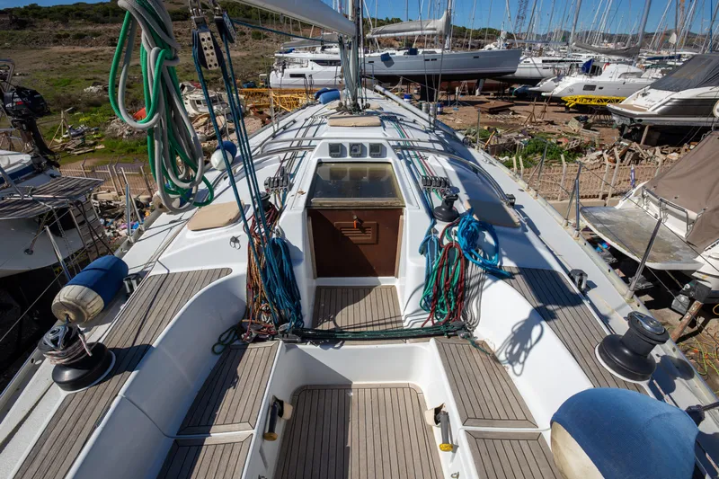  Yacht Photos Pics 2005 Grand Soleil 43 sailboat deck with rigging and winches in a marina setting.