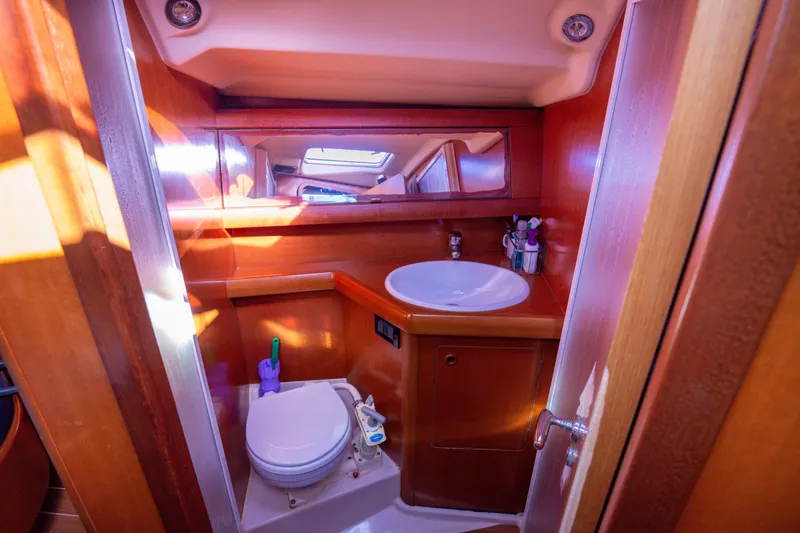  Yacht Photos Pics Luxurious 2005 Grand Soleil 43 yacht bathroom with wooden finish and modern amenities.