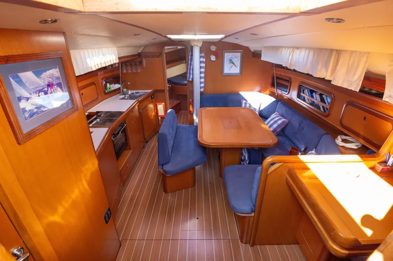  Yacht Photos Pics Luxurious 2005 Grand Soleil 43 yacht interior with cozy seating and elegant wood finishes.