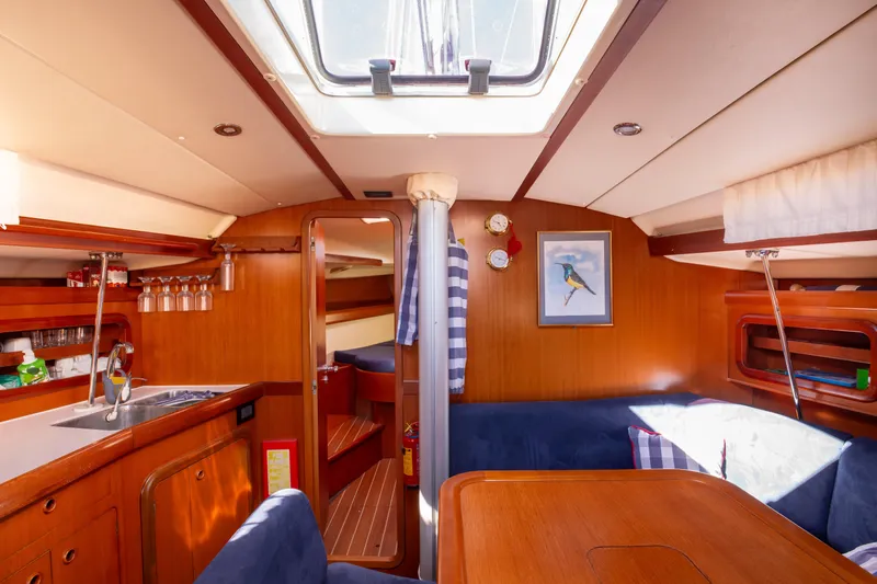  Yacht Photos Pics Interior of 2005 Grand Soleil 43 yacht with cozy wooden furnishings and natural light.