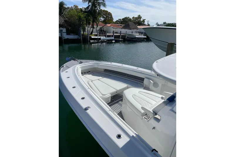  Yacht Photos Pics 2019 HCB 42 Siesta boat with white seating, docked near waterfront homes.