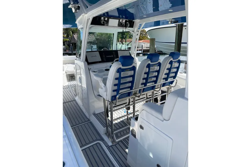  Yacht Photos Pics 2019 HCB 42 Siesta boat interior with blue and white seating and navigation equipment.