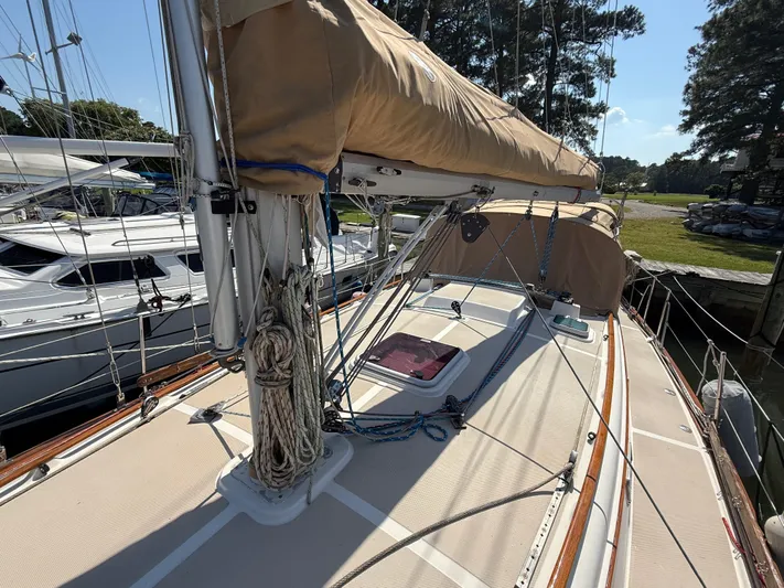 Moonsplash Yacht Photos Pics 1987 Island Packet 38 sailboat deck with rigging and tan sail cover, docked at marina.