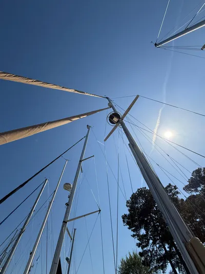 Moonsplash Yacht Photos Pics Masts of 1987 Island Packet 38 sailboat against clear blue sky.