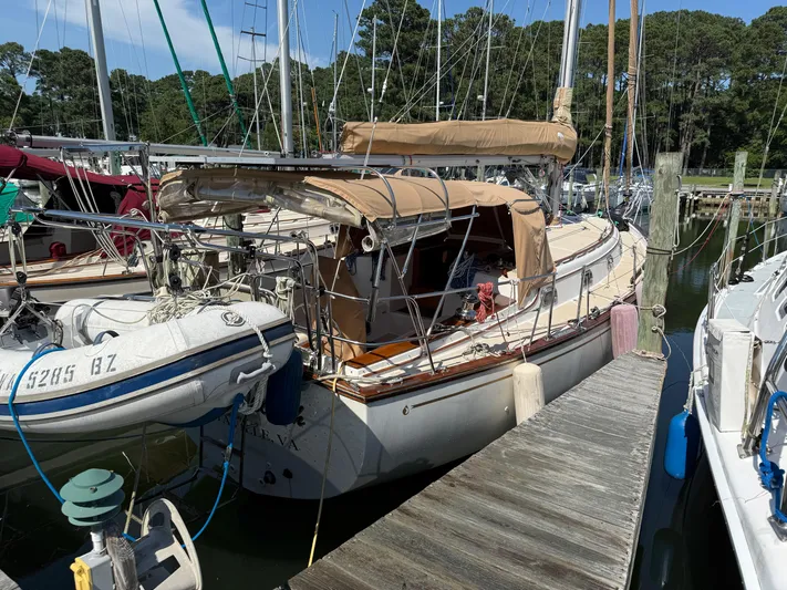Moonsplash Yacht Photos Pics 1987 Island Packet 38 sailboat docked with dinghy, surrounded by other boats.