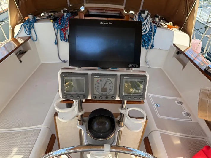 Moonsplash Yacht Photos Pics Cockpit of 1987 Island Packet 38 sailboat with navigation instruments and steering wheel.