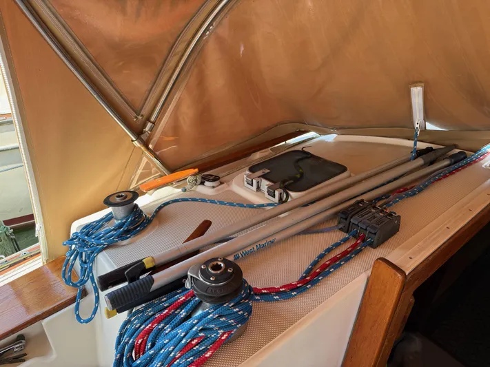 Moonsplash Yacht Photos Pics 1987 Island Packet 38 sailboat deck with ropes and equipment under a canopy.